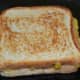 Step eight: Sprinkle some ghee or butter on the pan. Toast the sandwich till golden brown on both sides.
