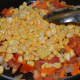 Step five: Add corn. Cook for 4-5 minutes on low fire.
