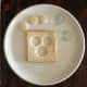 Cut out 3 circles in the shape of eyes and a nose in a slice of bread.