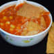Step six: Garnish with broken nacho chips and grated cheese. Enjoy sipping this delightful Mexican nacho soup!