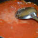 Step three: Make a puree of cooked tomatoes. Pour it into the pan. Add corn flour mix. Boil the mix.