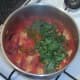 Chopped coriander is added to chicken stew