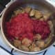 Tomatoes and paste are added to turkey