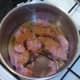 Turkey is added to cooking pot and seasoned and spiced
