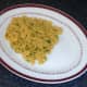 Turmeric rice bed is arranged on serving plate