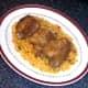 Chicken thighs are laid on rice bed