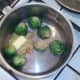 Butter, garlic and ginger are added to drained sprouts