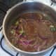 Stock is added to beef and brought to a simmer