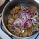 Red onion and garlic are added to sealed turkey