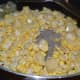 Step three: Add sweet corn kernels, pepper powder, and salt. Mix well.