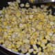 Step four: Increase the fire and stir-cook for 2 minutes. Add a very small amount of water and cover the pan. Cook for 3 minutes over low fire.