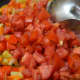Step seven: Add tomatoes and continue to cook.