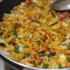 Step nine: Ensure the fine mixing of the spices and seasonings with the rice flakes. Poha chivda is ready to munch.