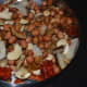 Step four: Strain and transfer the contents to a plate. Leave some oil in the pan.