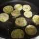 add coated tomatoes to hot oil