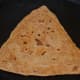 Step eleven: Remove and place it on a plate. Make all the parathas like this.