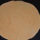 Step four: Dust the ball with wheat flour. Roll it into about 6 inch diameter disc.