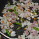 Step two: Add chopped onions and slit green chilies. Continue sauteing till the onion turns transparent and pinkish.