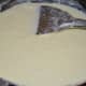 Step four: Continue stirring over low heat. You will see that the milk has changed into granules. Add sugar.