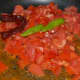 Step one: Saute green chili, red chili, and tomatoes in some oil.
