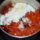 Step four: Add cooked tomato mix and yogurt. Grind to get a smooth mix.