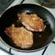 Pork steaks are gently shallow fried