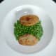 Fried potato and peas are plated