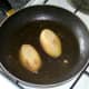 Cooled potato halves are fried on both sides