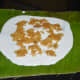 The batter and the stuffing spread on a banana leaf for making the dumplings