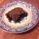 Let the brownie cool in the pan or eat it warm. Just don't burn your fingers. Add the powdered sugar if you'd like. Now look at this delicious masterpiece. Omg!!! Yes!! Eat that delicious brownie and enjoy!