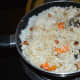 Step four: Add cooked rice with carrot cubes. Gently mix together. Add salt and sugar as per taste.