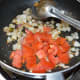Throw in the chopped tomatoes. Continue stir-cooking until they become tender but not mushy.