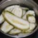 Step one: Wash raw bananas. Peel the skin. Slice them lengthwise to get long pieces. Immerse the slices in water and drain.