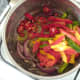 Peppers are added to sauteed onion