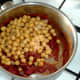 Chickpeas are added to spicy sauce