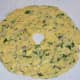 Step 5: Divide the dough into four equal portions. Make a patty out of one of the portions on a greased plastic sheet. Apply water to your fingers and expand it to make a disc of about six inches in diameter. Make a big hole in the center.