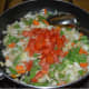 Step Five: Add chopped tomatoes. Continue stir-cooking till the tomato becomes soft.