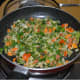 Cooking the fenugreek leaves into the veggies