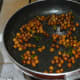 Throw in cooked chickpeas. Add sugar and very little salt. Mix well.