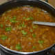 Step seven: Add vinegar. Mix well. Turn off the stove. Garnish the soup with chopped coriander leaves.
