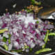 2. Add chopped onions, salt, and slit green chilies. Increase the heat. Saute till onions become translucent.