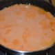 Step nine: Heat oil in a deep-bottomed pan. Pour the tomato gravy.