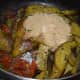 Step ten: Add cooked eggplant slices. Add roasted peanut powder. Throw in sugar and hing powder. Mix well.