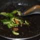 Step three: Heat oil in a deep-bottomed pan. Add mustard seeds. Let them crackle. Throw in hing powder. Saute for few seconds. Throw in slit green chilies and curry leaves. Saute further for a minute.