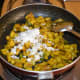 Step seven: Add grated coconut. Mix well. Turn off the heat.