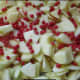 spread red hots across apples in pan