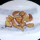 Oven cooked chips are drained on kitchen paper