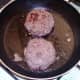 Burgers are turned to fry on second side