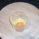 Egg broken in to small glass