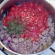 Tomatoes and chillies are added to browned lamb